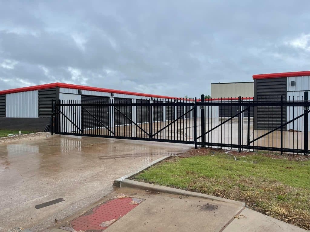 ornamental fence with entranceway surrounding building
