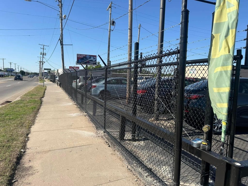 commerical fence surrounding parking lot