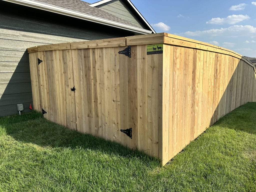 wooden fence surrounding home with entranceway